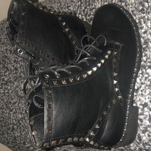 Black faux leather studded combat boots.